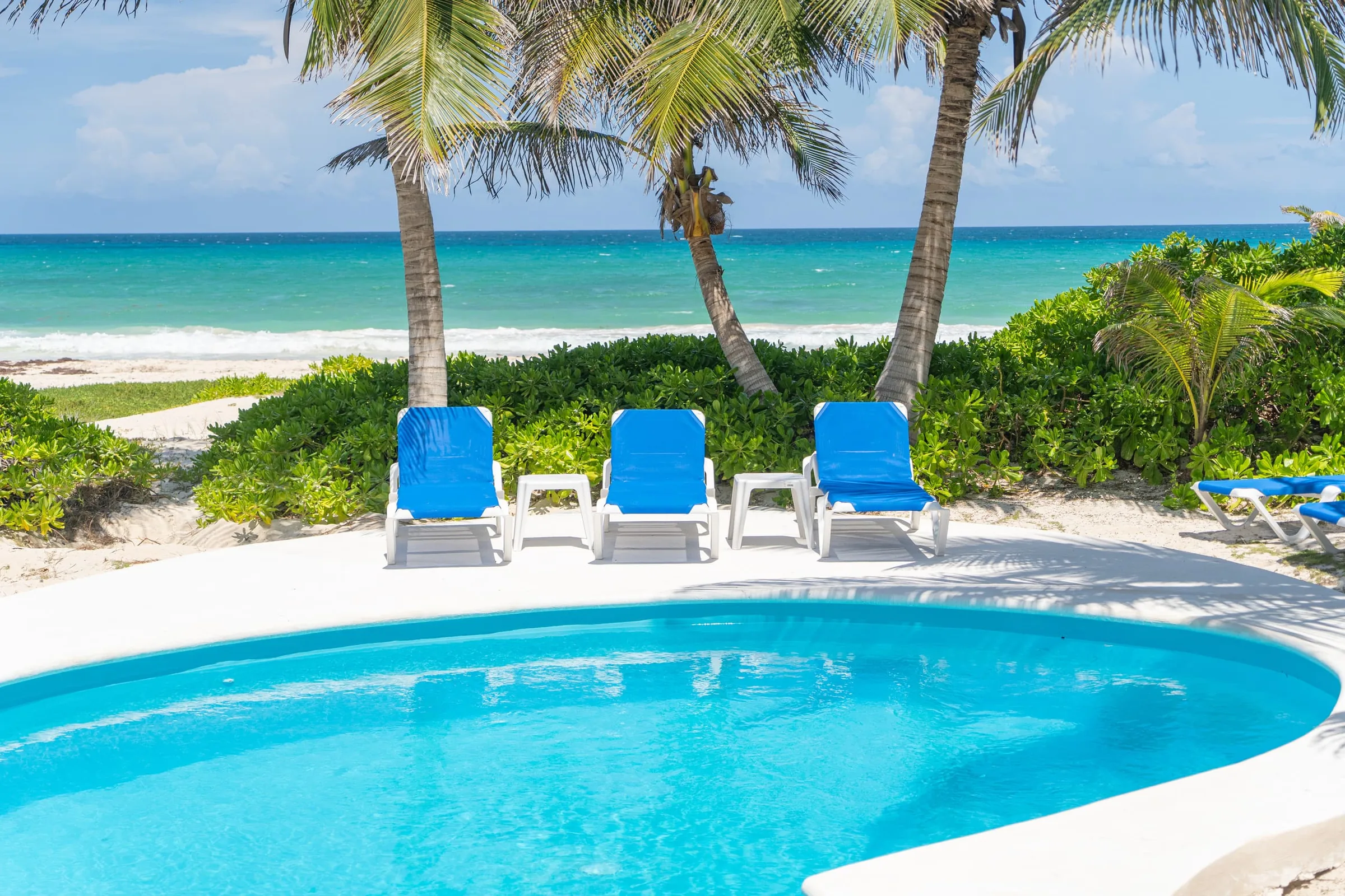 Pool and loungers with the Caribbean behind
